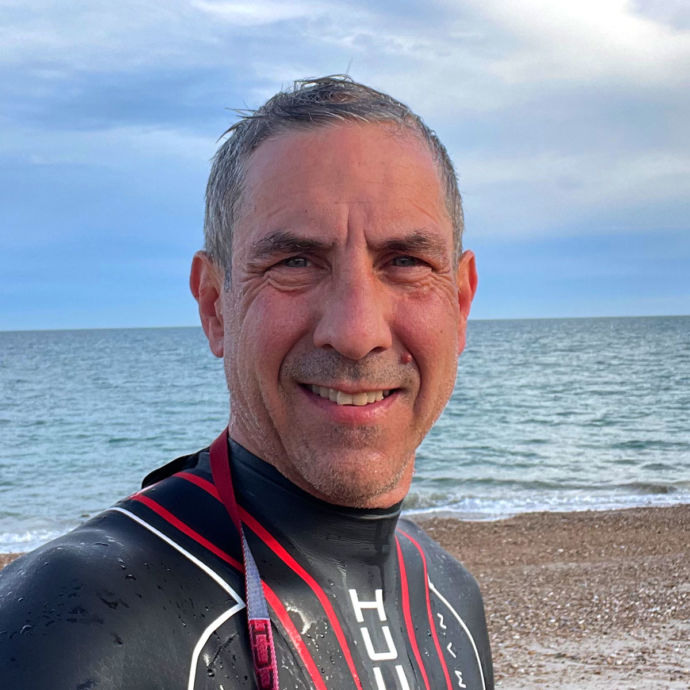 Chichester Triathlon Club - Kevin Dowling open water swim training on a beach in a Huub on a beach in West Sussex