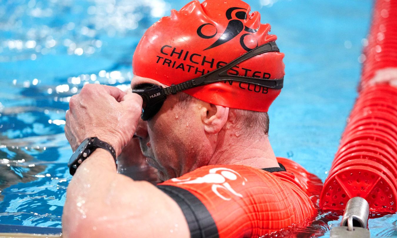 Chichester Triathlon Club member. adjusting goggles before swim training session