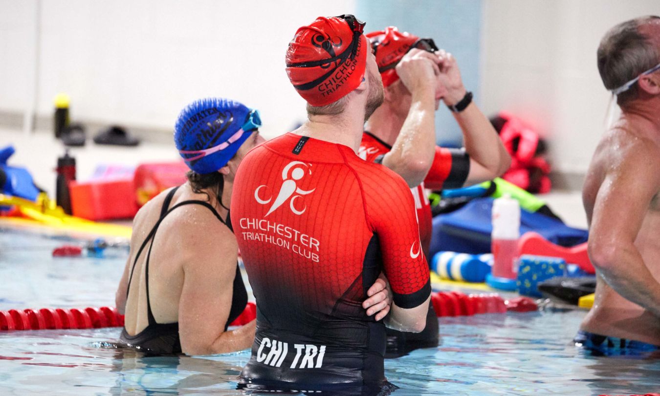 Chichester Triathlon Club members listening to coaches during a swim training session